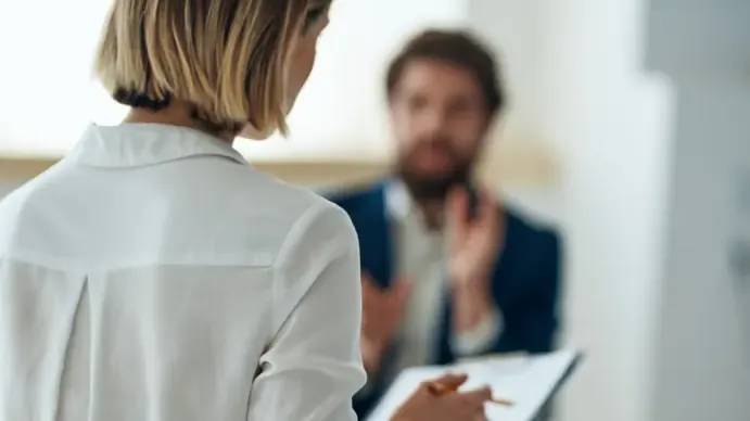 Adviser with a notepad in conversation with a customer