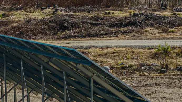 Solar panels on steel mounting frames under construction on a cleared site